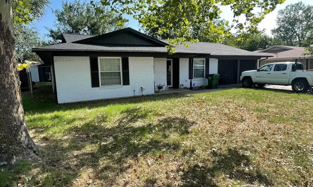 Professional roofing crew working on a residential roof in Thornapple